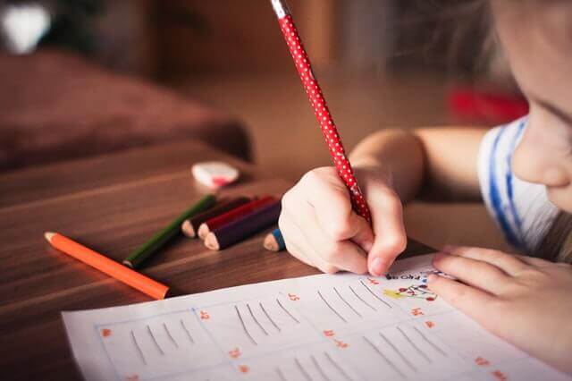 close up of child working at a school desk