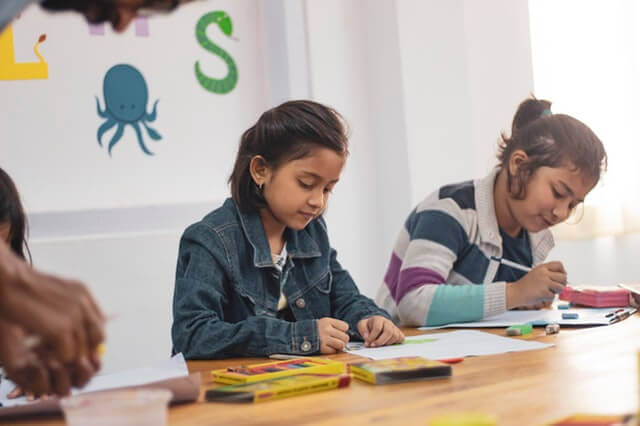 two children working at a school desk