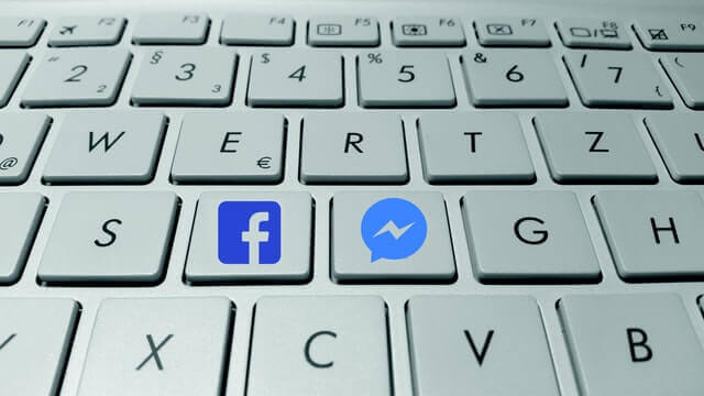 close-up of computer keyboard with social media icons on two of the keys