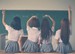 4 school children facing a blackboard