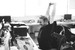 black and white image of man stretching at his desk
